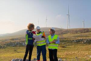 A team of engineers and workers oversees a wind turbine project at a modern wind farm, working together to ensure the efficient generation of renewable energy photo