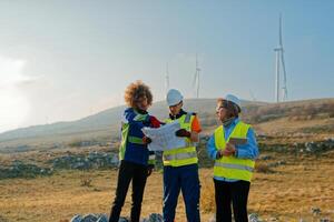 A team of engineers and workers oversees a wind turbine project at a modern wind farm, working together to ensure the efficient generation of renewable energy photo