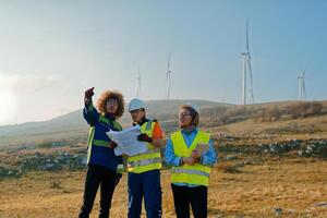 A team of engineers and workers oversees a wind turbine project at a modern wind farm, working together to ensure the efficient generation of renewable energy photo