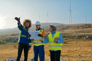 A team of engineers and workers oversees a wind turbine project at a modern wind farm, working together to ensure the efficient generation of renewable energy photo