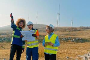 A team of engineers and workers oversees a wind turbine project at a modern wind farm, working together to ensure the efficient generation of renewable energy photo