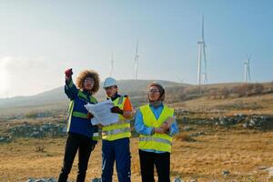 A team of engineers and workers oversees a wind turbine project at a modern wind farm, working together to ensure the efficient generation of renewable energy photo