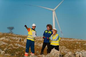 A team of engineers and workers oversees a wind turbine project at a modern wind farm, working together to ensure the efficient generation of renewable energy photo