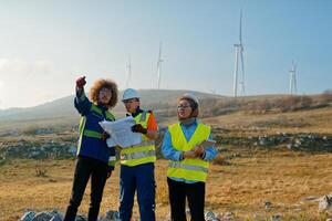 A team of engineers and workers oversees a wind turbine project at a modern wind farm, working together to ensure the efficient generation of renewable energy photo