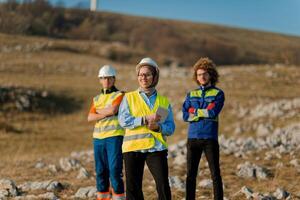 A team of engineers and workers oversees a wind turbine project at a modern wind farm, working together to ensure the efficient generation of renewable energy photo