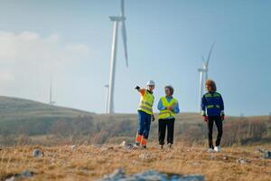 A team of engineers and workers oversees a wind turbine project at a modern wind farm, working together to ensure the efficient generation of renewable energy photo
