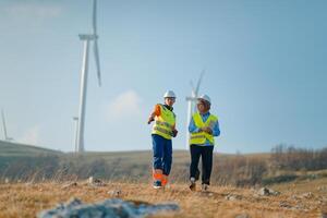 A team of engineers and workers oversees a wind turbine project at a modern wind farm, working together to ensure the efficient generation of renewable energy photo