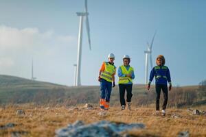 A team of engineers and workers oversees a wind turbine project at a modern wind farm, working together to ensure the efficient generation of renewable energy photo