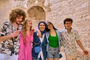 A diverse group of tourists, dressed in summer attire, strolls through the tourist city with wide smiles, enjoying their sightseeing adventure photo