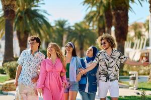 A diverse group of tourists, dressed in summer attire, strolls through the tourist city with wide smiles, enjoying their sightseeing adventure photo
