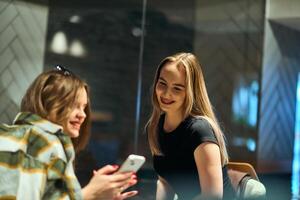 Catching Up and Connecting. Friends Enjoy Coffee and Conversation at a Cozy Cafe photo
