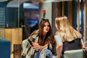 Catching Up and Connecting. Friends Enjoy Coffee and Conversation at a Cozy Cafe photo