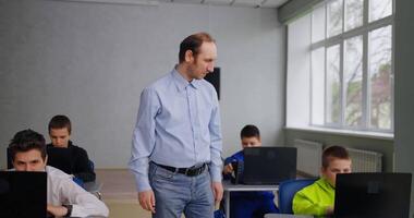 Teacher Of Programming And Coding Courses For Children Walking In Classroom, Computer Science Lesson video