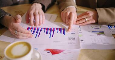 Financial Analysts Viewing Reports With Sales Diagrams, Discussing Strategy Of Company, Closeup View video