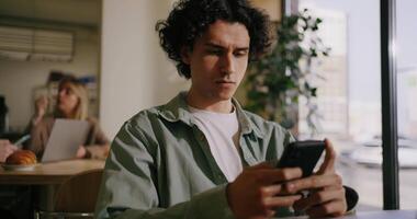 Hispanic Man Chatting Online In Mobile App, Sitting In Cafe In Lunchtime, Messaging In Work Chat video