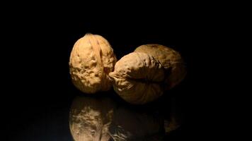 Walnuts in rotation on black background video