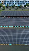 Aerial view of electric cars charging in a parking lot with solar panel energy video