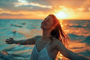 A woman is smiling and splashing in the ocean photo