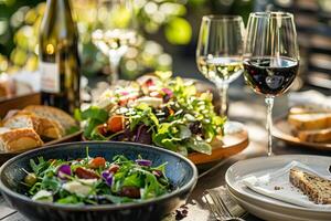 A table with a variety of food and drinks, including a salad, pizza, and wine photo