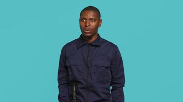 Security guard in uniform feeling amazed while at work, saying wow. Portrait of awestruck bodyguard being astonished during protection job shift, studio background, camera A video