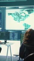 Vertical Cyber operations center with governmental hackers working on digital security activities during hybrid war. Specialists team ensuring security and malware detection, cyber surveillance. Camera B. video