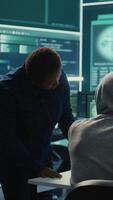 Vertical Governmental hackers doing teamwork in protecting sensitive information from cyber threats of digital mercenaries. Experts focusing on online security and cyber defense tactics. Camera B. video