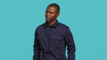 Anxious security guard shaking head, having trouble following orders during protection job shift. Portrait of troubled bodyguard feeling stressed, having problems at work, studio background, camera A video