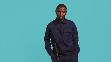 Security guard turning on flashlight, being tasked with preventing criminal activity and detaining suspects performing crimes. Portrait of bodyguard using lantern device, studio background, camera B video