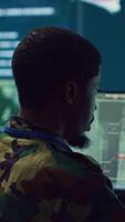 Vertical Army officer develops contingency plans to address unexpected developments in the field, studying real time satellite intelligence in military command post. Soldier tracking enemy servers. Camera A. video
