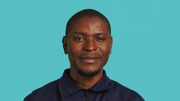 Portrait of security agent celebrating achievements after securing assigned post, studio background. Close up of guardian feeling satisfied after completing tasks, handling security breaches, camera A video