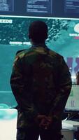 Vertical Staff sergeant monitoring satellite live imagery on a big screen, gathering information for future military operations. Army officer employs reconnaissance system in command post. Camera A. video