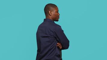 Portrait of security staff member tasked with evicting trespassers while following legal protocols. Patrolling agent maintaining secure environment, studio background, camera A video