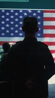Vertical US military man supervising threat detection activity in high tech office, examining top secret data on big screen. Governmental soldiers managing hybrid war, cyber attack prevention. Camera B. video