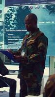 Vertical General headquarters under ruling of army IT professional that reviews insight about a new national safety mission. Command sergeant major briefing his marine corps troops with big data. Camera B. video
