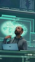 Vertical Governmental hacker examines info on a big screen in agency office, using advanced technology to secure computer networks. Working on cyber security and defending against cyberwarfare. Camera B. video