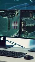 Vertical Empty military drone control monitoring room equipped with a big screen, satellite radar footage running surveillance system. National armed forces headquarters with high tech. video