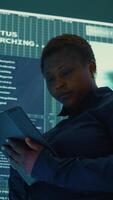 Vertical Cyber intelligence specialist examines data on big screen in a governmental agency, focusing on cyber defense and protection against cyber attacks. Private information in hybrid war. Camera B. video