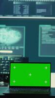 Vertical Isolated copy space running on a laptop in high tech agency office, governmental hackers analyzing digital threats on big screens. Working on cybercrime and protection against phishing. Camera B. video