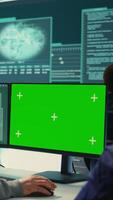 Vertical Governmental hackers working on computer with green screen to protect data and network security. Focusing on cyber defense, malware detection to prevent cyber attacks and espionage. Camera B. video