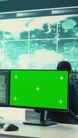Vertical Hacking specialist works with an isolated chroma key display in high tech agency office, securing national servers with state secrets. Governmental hacker examines threat detection measures. Camera B. video