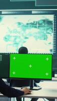 Vertical Governmental hackers using green screen in performing cyber security monitoring and threat detection. Examining network security and protection against cyber attacks, national intelligence. Camera B. video