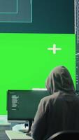 Vertical Team of governmental hackers look at green screen in high tech agency office, working together on hacking database systems for cyberwarfare activity. Experts conducting illegal scams. Camera B. video