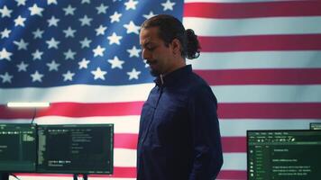 An American hacker in a governmental cyber defense room, showcasing advanced technology and hacking tools. Working on cybersecurity monitoring, digital security and national security. Camera A. video