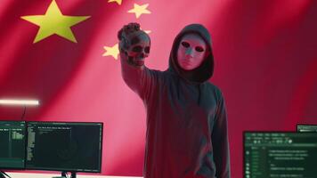Chinese man presenting a human skull to make death threats, symbolizing criminal activity. Hacker asking for ransom after breaking into governmental security systems, digital mercenary work. Camera A. video