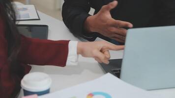 Group of casually dressed asian businesspeople discussing ideas in the office. Creative professionals gathered at the meeting table for discuss important issues of the new successful startup project video