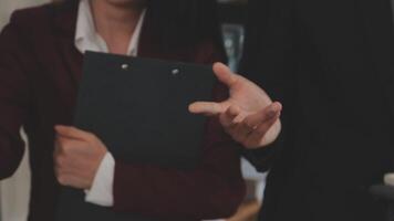 Group of casually dressed asian businesspeople discussing ideas in the office. Creative professionals gathered at the meeting table for discuss important issues of the new successful startup project video