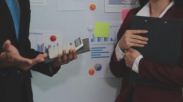 Group of casually dressed asian businesspeople discussing ideas in the office. Creative professionals gathered at the meeting table for discuss important issues of the new successful startup project video
