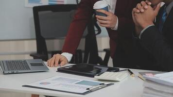 Group of casually dressed asian businesspeople discussing ideas in the office. Creative professionals gathered at the meeting table for discuss important issues of the new successful startup project video