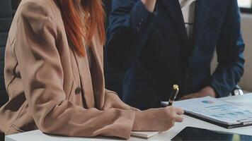 Group of casually dressed asian businesspeople discussing ideas in the office. Creative professionals gathered at the meeting table for discuss important issues of the new successful startup project video