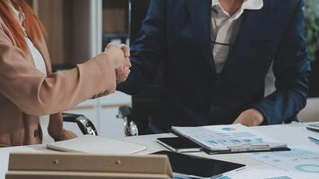 Group of casually dressed asian businesspeople discussing ideas in the office. Creative professionals gathered at the meeting table for discuss important issues of the new successful startup project video